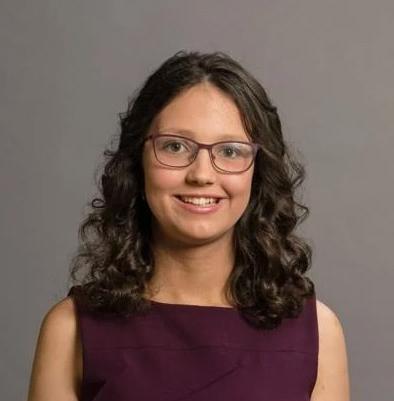 Aaliyah A. from Indiana Connections Academy wearing an eggplant purple dress smiling at the camera. 